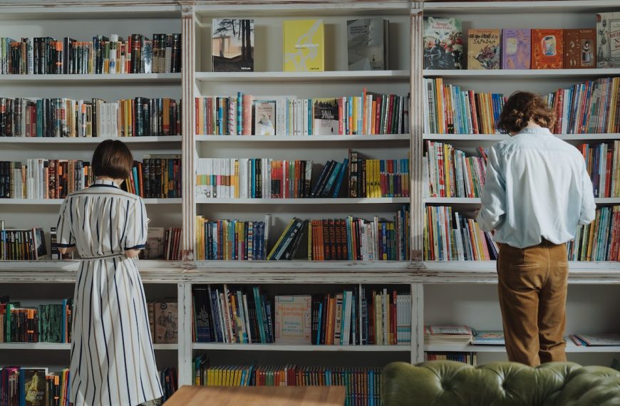 man and woman choosing books